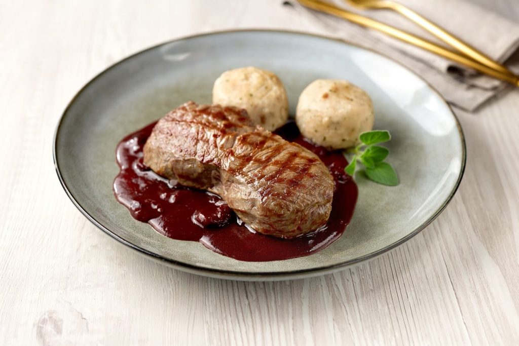 Beef steak with cranberry sauce and bread dumplings